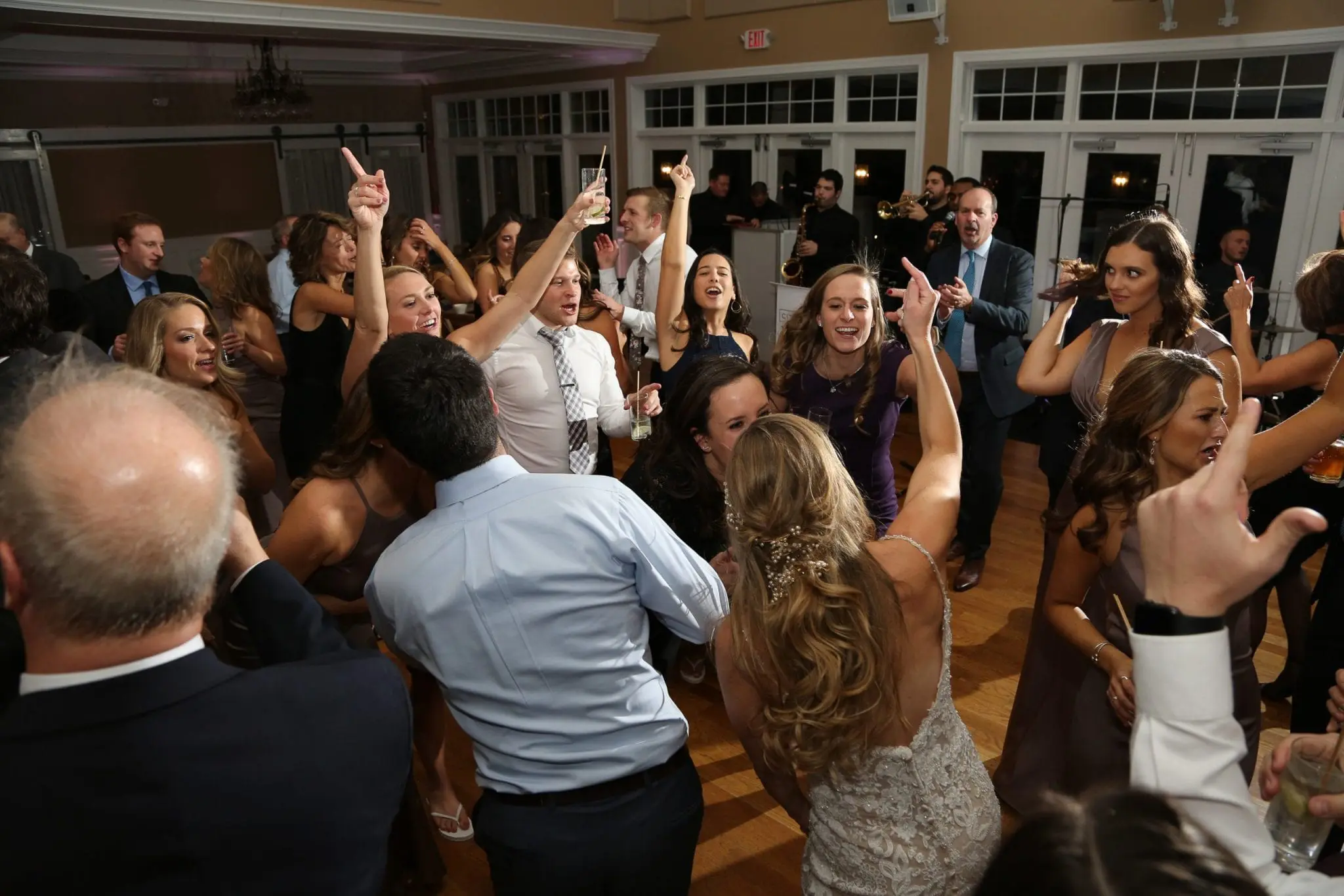 Wedding guests dancing on the dance floor having a good time | Elegant Music Group - EMG
