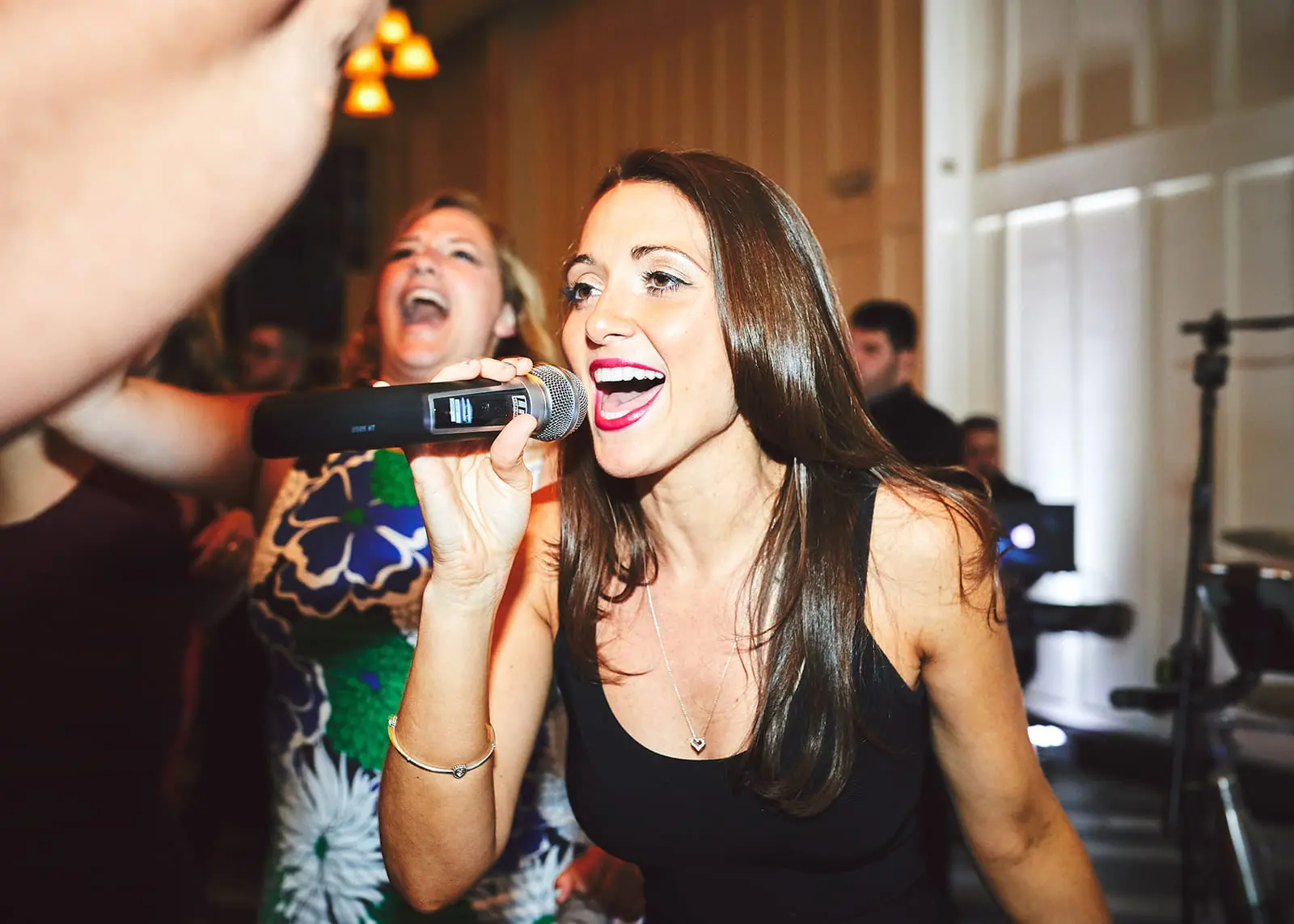 A woman singing into a dynamic microphone.