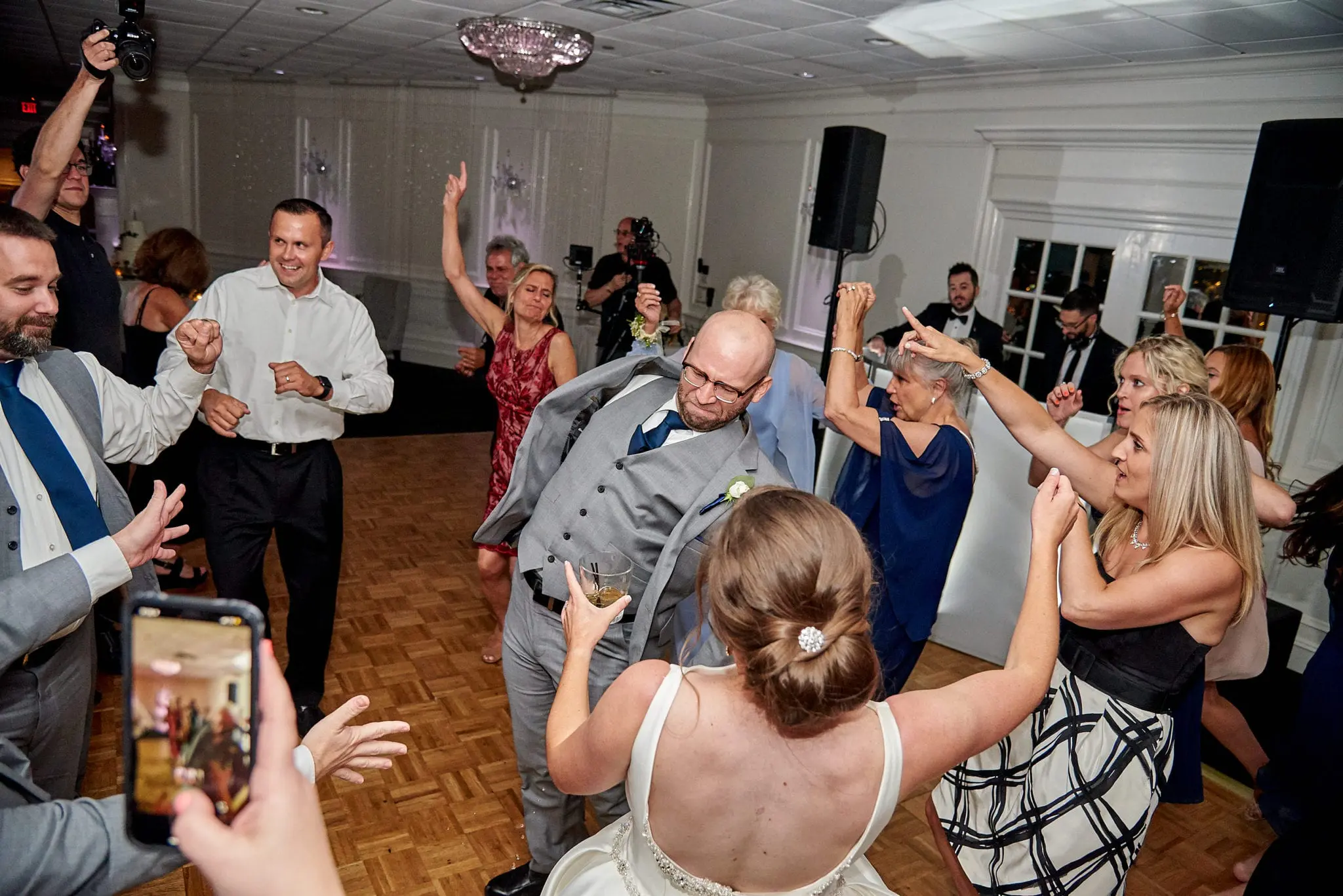 Wedding guests dancing at a reception.