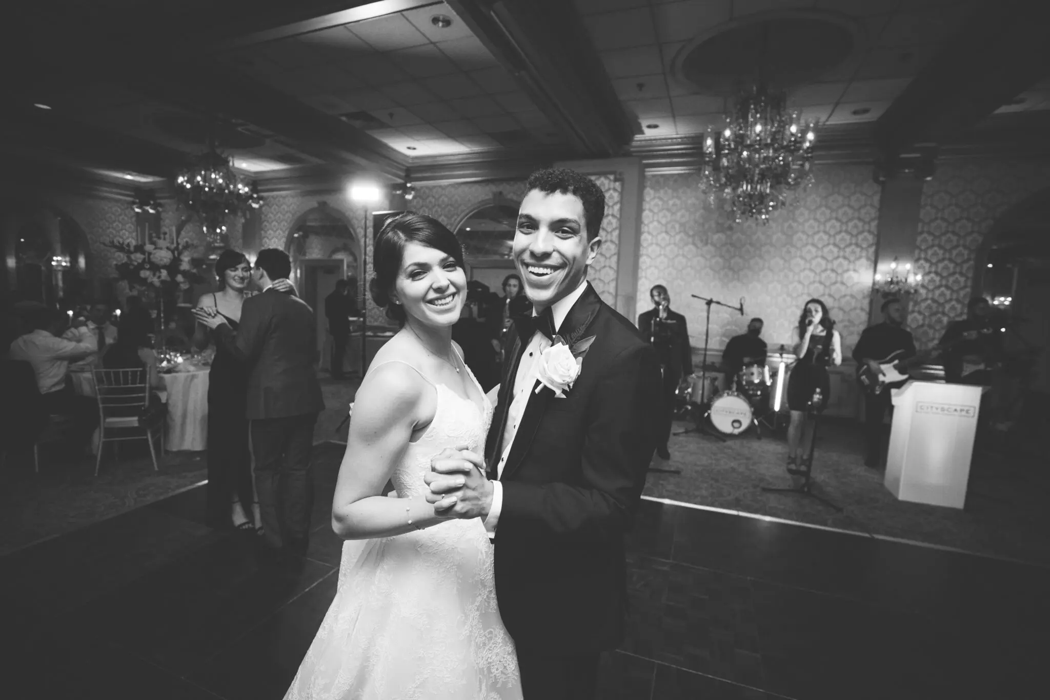 Bride and groom smiling on dance floor | Elegant Music Group