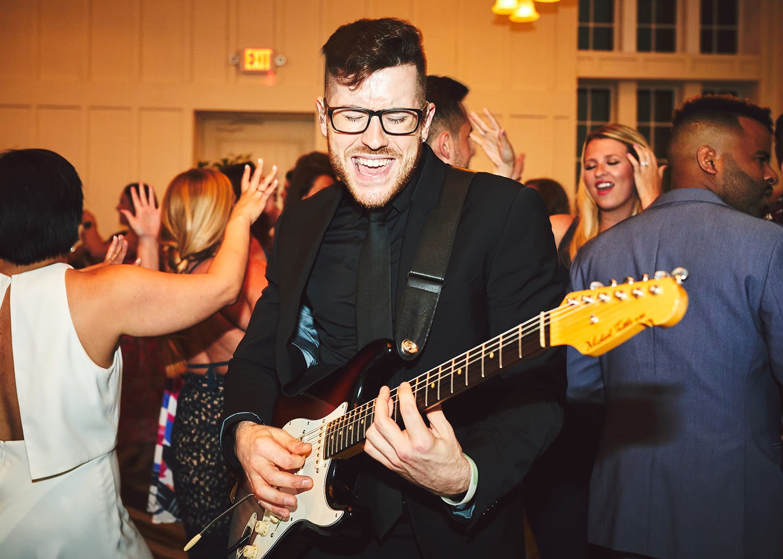 Mike Carleo of Elegant Music Group dancing, singing, and playing his guitar